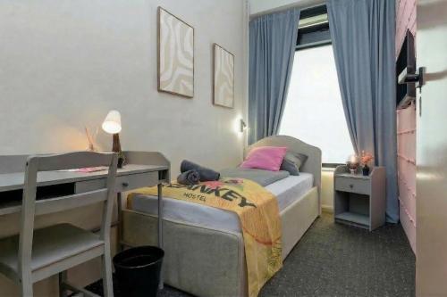a small bedroom with a bed and a desk at UrbanKey Studios - Vienna Mitte in Vienna