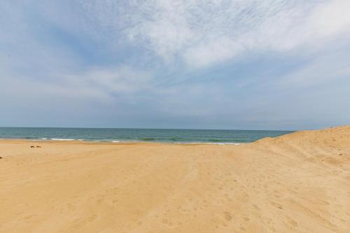 a sandy beach with the ocean in the background at 5441 - Rascoe in Nags Head