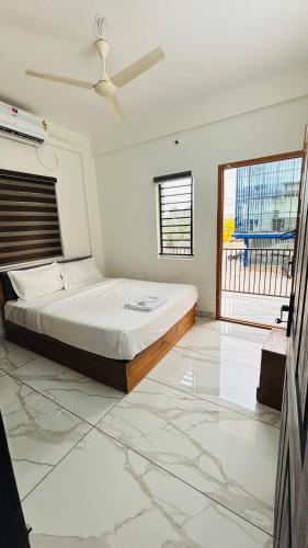 a bedroom with a bed and a large window at MIRACLE inn NEAR AL-AMEEN COLLEGE in Alwaye