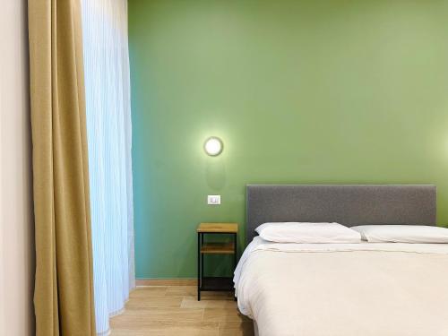a bedroom with a bed and a clock on the wall at Casa Genzino in Molfetta