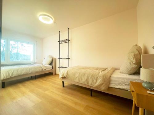 a bedroom with two beds and a window at Schönes Apartment Traumblick mit Balkon Bad Ems in Bad Ems