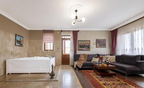 a living room with a couch and a table at Yellow Stone House in Göreme