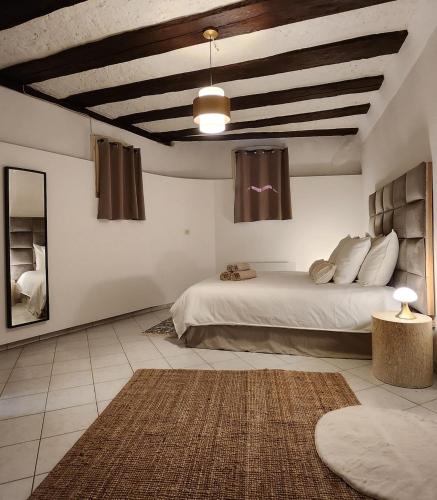 a bedroom with a large bed in a room at Logement atypique en souplex in Sélestat