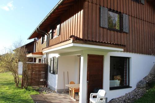 a wooden house with a bench in front of it at Ferienhaus Alpkönigin in Missen-Wilhams