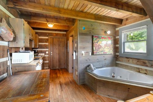 a bathroom with a large tub in a cabin at Rustic Mountain Escape with Fire Pit and Mountain Views-Cabin 1 in Fancy Gap