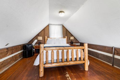 a bedroom with a bed in a attic at Rustic Mountain Escape with Fire Pit and Mountain Views-Cabin 1 in Fancy Gap