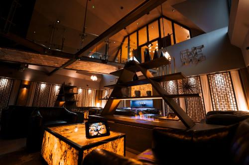 a living room with a wooden table and a couch at Cave Hotel & Golf Resort in Faversham