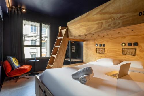a bedroom with a bunk bed and a chair at JO&JOE Paris - Nation in Paris