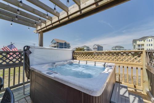 a jacuzzi tub on the deck of a house at 7039 - A Wave From It All in Rodanthe