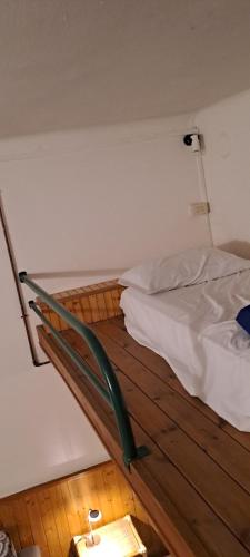 a bedroom with a bed with a wooden floor at Casa Pina in Como