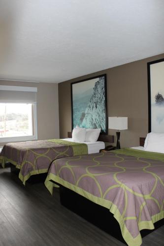 a hotel room with two beds and a large window at Super 8 by Wyndham Fort Chiswell Wytheville Area in Max Meadows