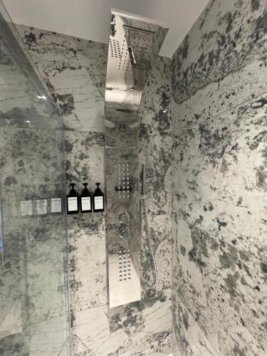 a bathroom with a shower with a glass door at Pawlina Boutique Residence in St. Paul's Bay