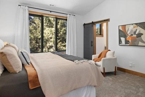 a bedroom with a bed and a chair and a window at Onyx in Cle Elum