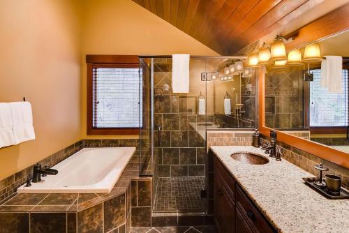a bathroom with a tub and a shower and a sink at Crestview Lodge in Ronald