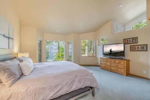 a bedroom with a large bed and a flat screen tv at Lakeside in Ronald