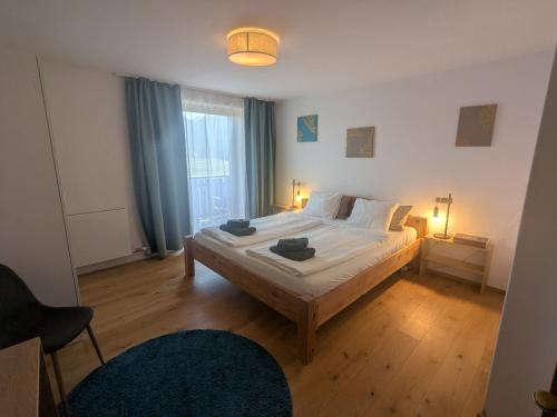 a bedroom with a large bed with two candles on it at Apartment L i e b l i n g s o r t in Golling an der Salzach