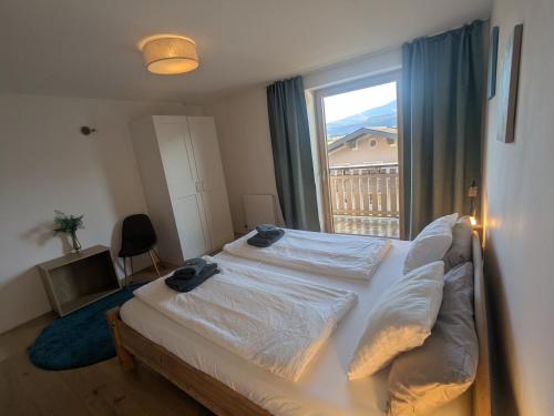 a bedroom with a large bed with a window at Apartment L i e b l i n g s o r t in Golling an der Salzach