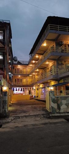 a large building with an empty parking lot at night at Hotel Lake shadow inn in Pokhara
