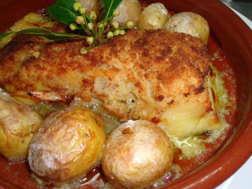 a red bowl of food with meat and potatoes at Casa da Fonte Sagrada in Loriga