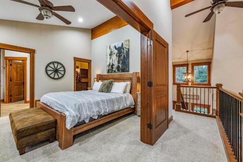 a bedroom with a bed and a ceiling fan at Grand Alpine Lodge in Ronald
