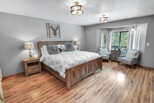 a bedroom with a bed and a desk and a chair at Driftwood in Ronald