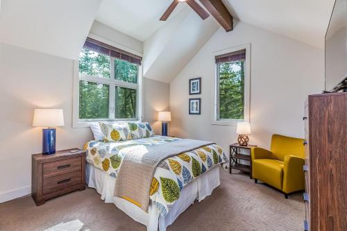 a bedroom with a bed and a yellow chair at Majestic Pines in Ronald