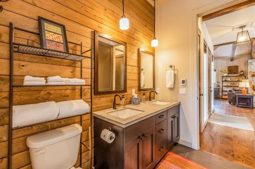 a bathroom with a toilet and a sink and a mirror at Majestic Pines in Ronald