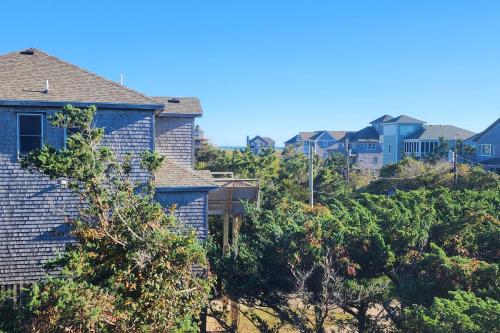 a group of houses on a hill with trees at 7838 - Wilder View in Frisco