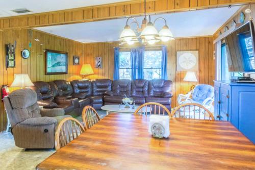 a living room with a table and leather furniture at 7602 - Drydock in Avon