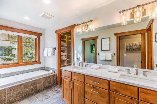 a bathroom with two sinks and a tub and a shower at Wine Down in Cle Elum