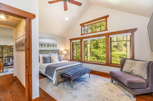a bedroom with a bed and a couch and windows at Wine Down in Cle Elum