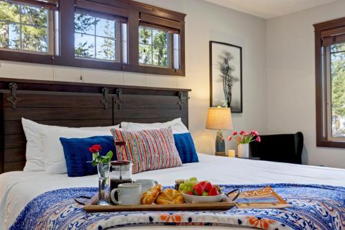 a breakfast tray on a bed with food on it at Basecamp at Suncadia in Cle Elum
