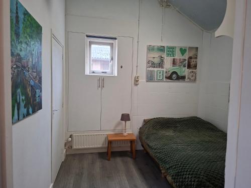 a bedroom with a bed and a small table at Zonneoord in Ede