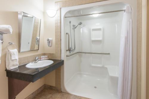 a bathroom with a shower and a sink at Canalta Wainwright in Wainwright