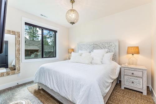 a white bedroom with a bed and a window at Suncadia Luxe in Cle Elum