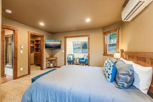 a bedroom with a large bed and a television at Huckleberry Hill in Ronald