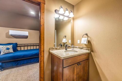 a bathroom with a sink and a blue bench at Huckleberry Hill in Ronald