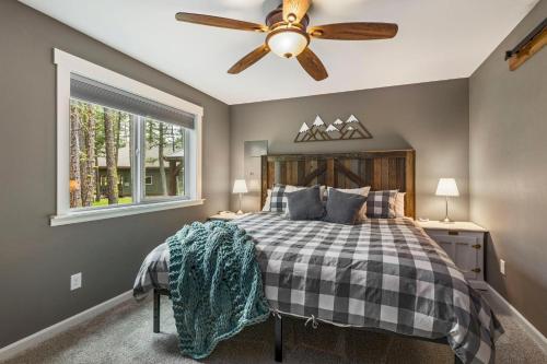 a bedroom with a bed with a ceiling fan at Crimson Cabin in Ronald