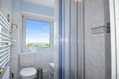 a bathroom with a window and a toilet and a shower at fewo1846 - Ostseebad - Apartment mit 2 Schlafzimmern und Meerblick in Flensburg