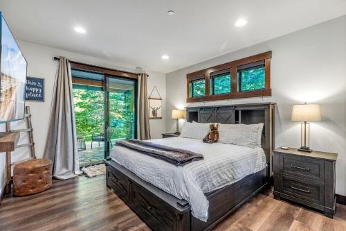 a bedroom with a bed with a dog sitting on it at Cabin at the Crest in Ronald