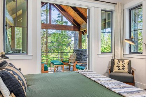 a bedroom with a bed in front of a window at Pine Meadow Lodge in Cle Elum