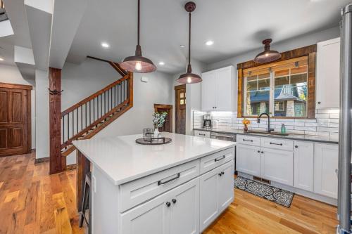 a kitchen with white cabinets and a large island at Ridgeview in Cle Elum