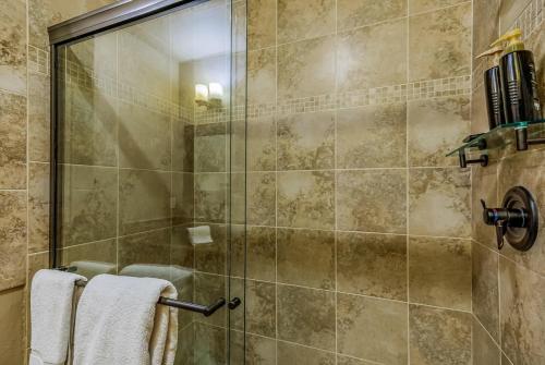 a shower with a glass door in a bathroom at 7th Heaven in Cle Elum