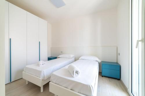 two beds in a room with white walls at Camilla al mare in Tortoreto Lido