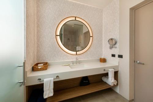a bathroom with a sink and a mirror at Punta Sal Suites & Bungalows Resort in Canoas de Punta Sal