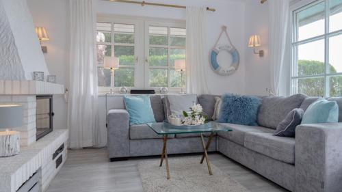 a living room with a couch and a table at Ferienhaus Weitblick in Morsum