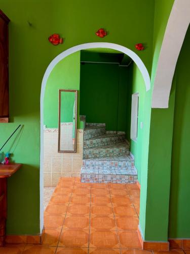 a green room with stairs and a green wall at Casza Grande Alojamiento in La Libertad