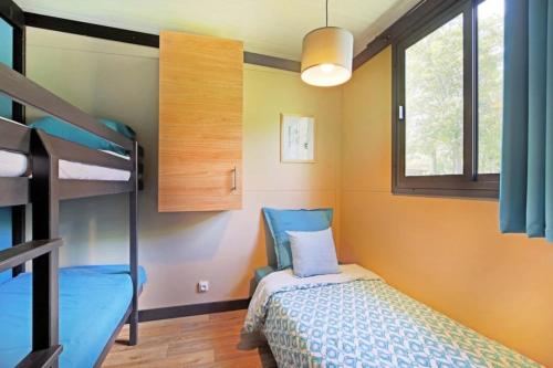 a small bedroom with a bunk bed and a bunk bed at Camping 3 étoiles - ccbfggd in Lepin-le-Lac