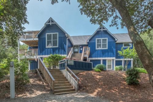 a blue house with stairs in front of it at 4620 - Flip Flop Inn in Southern Shores