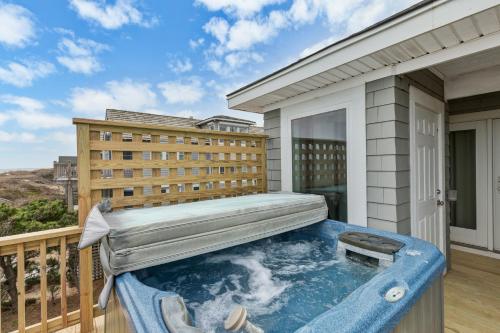 a hot tub on the balcony of a building at 2440 - Solitude South in Duck
